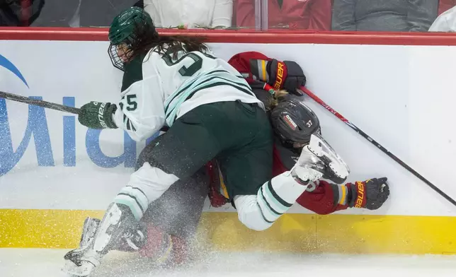 Boston Fleet defense Daniela Pejsova (55) sends Ottawa Charge forward Rebecca Leslie (37) into the boards during the first period of Game 4 in a PWHL hockey playoff series in Ottawa, Ontario, Sunday, May 10, 2026. (Adrian Wyld/The Canadian Press via AP)