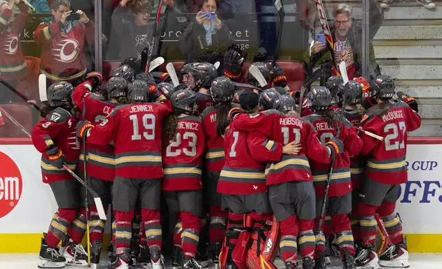 Ottawa Charge players celebrate after defeating the Boston Fleet in double overtime to win their PWHL hockey playoff series in Ottawa, Ontario, Sunday, May 10, 2026. (Adrian Wyld/The Canadian Press)