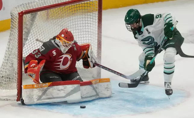 Boston Fleet forward Sophie Shirley (9) pressures Ottawa Charge goalie Gwyneth Philips (33) during the second period of Game 4 in a PWHL hockey playoff series in Ottawa, Ontario, Sunday, May 10, 2026. (Adrian Wyld/The Canadian Press via AP)