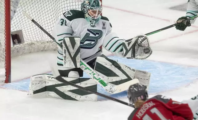 Boston Fleet goalie Aerin Frankel (31) makes a glove-save on a shot by Ottawa Charge's Brooke Hobson (11) during the first period of Game 4 in a PWHL hockey playoff series in Ottawa, Ontario, Sunday, May 10, 2026. (Adrian Wyld/The Canadian Press via AP)