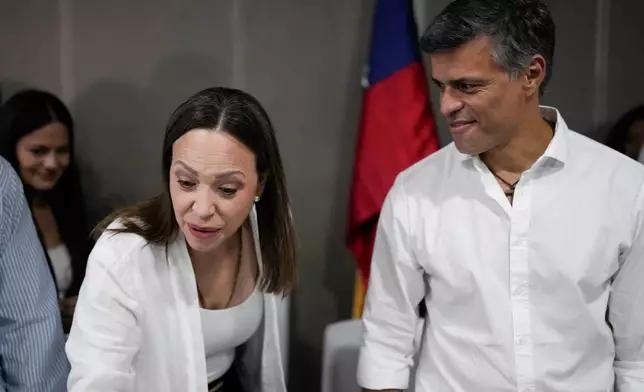 Venezuela's opposition activist Leopoldo Lopez, right, looks at opposition leader Maria Corina Machado after a press conference in Panama City, Saturday, May 23, 2026. (AP Photo/Matias Delacroix)