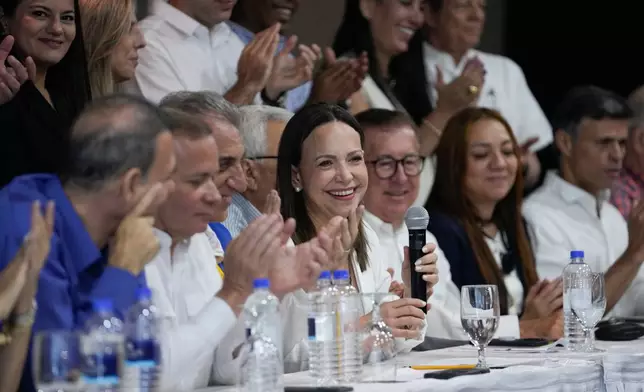 Venezuela's opposition leader Maria Corina Machado, center, attends a press conference in Panama City, Saturday, May 23, 2026. (AP Photo/Matias Delacroix)