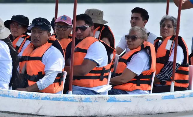 People search for migrants who vanished in late 2024 along a maritime smuggling route to the U.S., in San Jose Hueyate, Chiapas state, Mexico, Saturday, May 9, 2026. (AP Photo/Edgar H. Clemente)