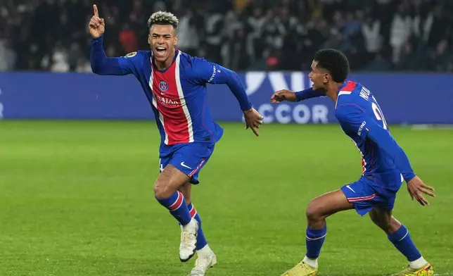 PSG's Desire Doue, left, celebrates scoring his side's opening goal during the French League One soccer match between Paris Saint Germain and Brest in Paris, France, Sunday, May 10, 2026. (AP Photo/Thibault Camus)