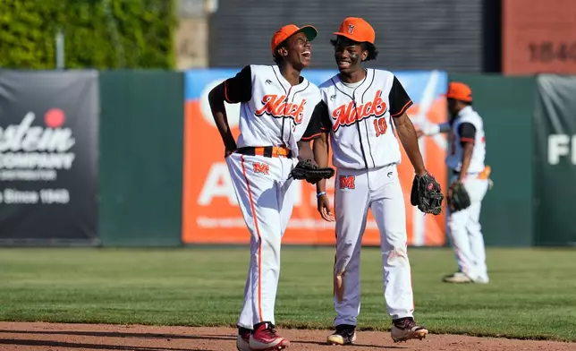 McClymonds High School Tyler Higginbotham, left, and Antuan Mason (10) share a laugh during the fourth inning of a baseball game against Skyline High School in Oakland, Calif., Friday, May 1, 2026. (AP Photo/Godofredo A. Vásquez)