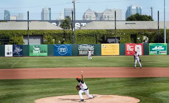 McClymonds High School pitcher Madden Kang (4) throws to a Skyline High School batter during the first inning of a baseball game in Oakland, Calif., Friday, May 1, 2026. (AP Photo/Godofredo A. Vásquez)
