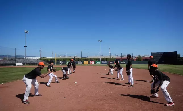 Players from the McClymonds High School baseball team practice fielding at Raimondi Field Wednesday, April 29, 2026, in Oakland, Calif. (AP Photo/Jeff Chiu)