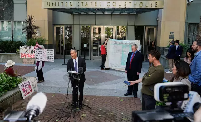 William Savitt, attorney representing OpenAI, center, speaks during a press conference outside the U.S. District Court in Oakland, Calif., Thursday, April 30, 2026. (AP Photo/Godofredo A. Vásquez)