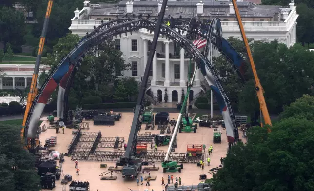 Equipment being placed on the South Lawn of the White House is seen from the Washington Monument, Tuesday, May 26, 2026, in Washington. The UFC is holding a mixed martial arts fight on June 14 as part of America 250 celebrations. (AP Photo/Mark Schiefelbein)