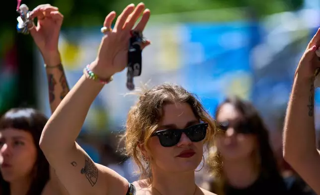 A woman holds up a set of keys as a symbol of protest during a protest in Madrid, Spain, Sunday, May 24, 2026, against rising housing costs that are pricing many Spaniards out of the market amid Spain's broader housing crisis.