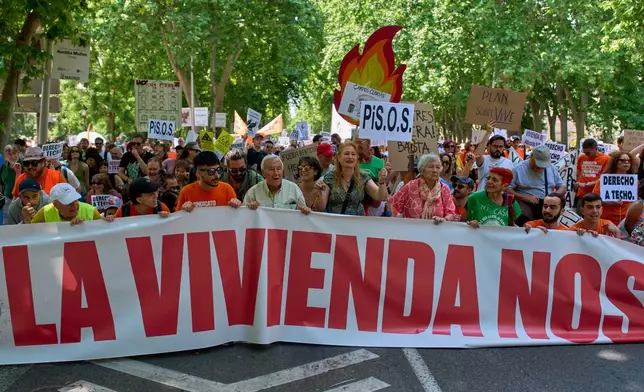 People take part during a protest in Madrid, Spain, Sunday, May 24, 2026, against rising housing costs that are pricing many Spaniards out of the market amid a broader housing crisis in Spain. (AP Photo/Manu Fernandez)