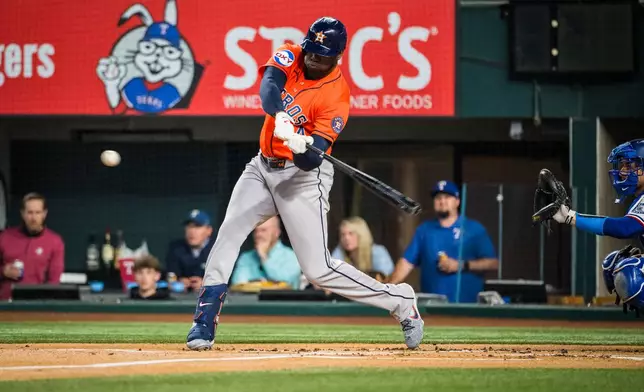 Houston Astros' designated hitter Yordan Alvarez bats during the first inning of a baseball game against the Texas Rangers, Tuesday, May 26, 2026, Arlington, Texas. (AP Photo/Jessica Tobias)