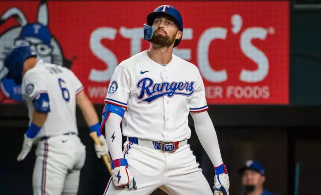 Texas Rangers' Brandon Nimmo reacts during the first inning of a baseball game against the Houston Astros, Tuesday, May 26, 2026, Arlington, Texas. (AP Photo/Jessica Tobias)