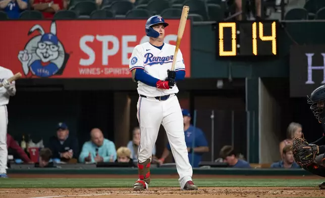 Texas Rangers' designated hitter Joc Pederson bats during the first inning of a baseball game against the Houston Astros, Tuesday, May 26, 2026, Arlington, Texas. (AP Photo/Jessica Tobias)
