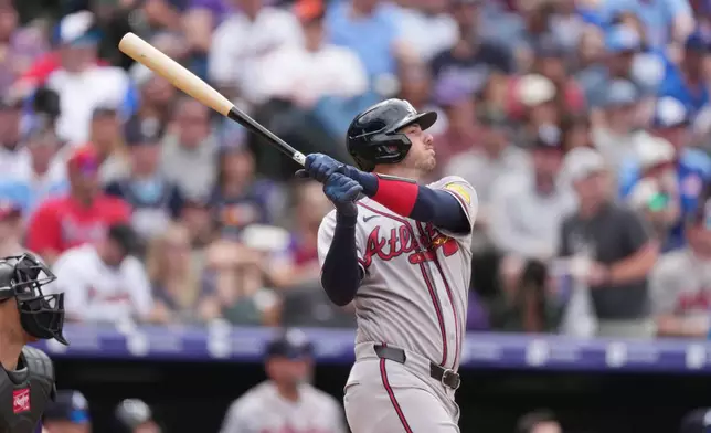 Atlanta Braves' Jonah Heim follows the flight of his sacrifice fly to drive in a run off Colorado Rockies relief pitcher Antonio Senzatela in the fifth inning of a baseball game, Sunday, May 3, 2026, in Denver. (AP Photo/David Zalubowski)