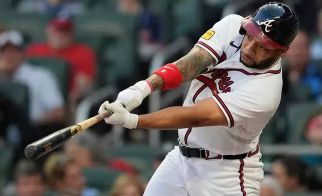 Atlanta Braves' Dominic Smith (8) hits a single in the third inning of a baseball game against the Chicago Cubs, Tuesday, May 12, 2026, in Atlanta. (AP Photo/Mike Stewart)