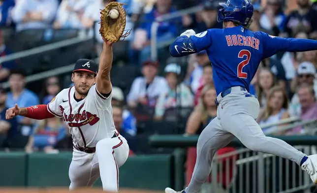 Atlanta Braves first baseman Matt Olson (28) makes the catch against Chicago Cubs' Nico Hoerner (2) in the first inning of a baseball game, Tuesday, May 12, 2026, in Atlanta. (AP Photo/Mike Stewart)