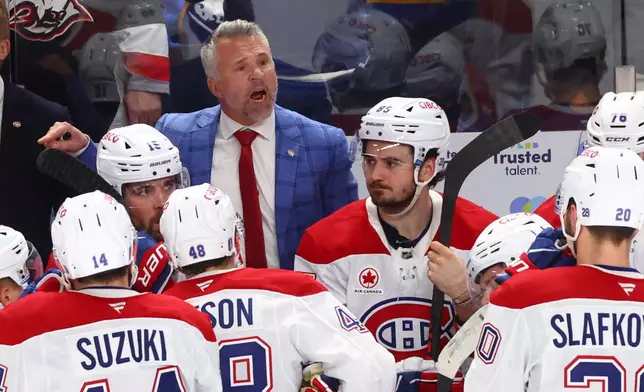 Montreal Canadiens head coach Martin St-Louis talks with team during the third period in Game 1 of a second-round NHL hockey Stanley Cup playoff series against the Buffalo Sabres Wednesday, May 6, 2026, in Buffalo, N.Y. (AP Photo/Jeffrey T. Barnes)