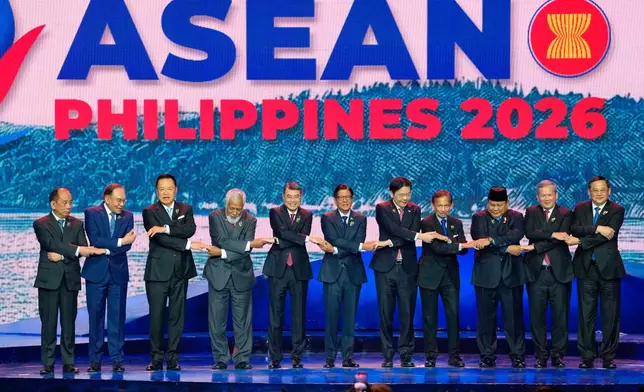 From left, Myanmar's Permanent Secretary of the Ministry of Foreign Affairs U Hau Khan Sum, Malaysia's Prime Minister Anwar Ibrahim, Thailand's Prime Minister Anutin Charnvirakul, East Timor's Prime Minister Xanana Gusmao, Vietnam's Prime Minister Le Minh Hung, Philippine President Ferdinand Marcos Jr., Singapore's Prime Minister Lawrence Wong, Brunei's Sultan Hassanal Bolkiah, Indonesia's President Prabowo Subianto, Cambodia's Prime Minister Hun Manet, and Laos' Prime Minister Sonexay Siphandone hold hands for a group photo during the opening ceremony of the 48th ASEAN summit and Related Meeting in Cebu, Philippines on Friday, May 8, 2026. (AP Photo/Aaron Favila, Pool)