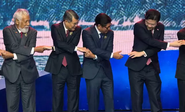 From left, East Timor's Prime Minister Xanana Gusmao, Vietnam's Prime Minister Le Minh Hung, Philippine President Ferdinand Marcos Jr. and Singapore's Prime Minister Lawrence Wong hold hands for a group photo during the opening ceremony of the 48th ASEAN Summit and Related Meetings in Cebu, Philippines on Friday, May 8, 2026. (AP Photo/Aaron Favila, Pool)