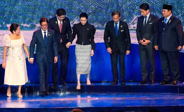 From left, Philippines first lady Maria Louise Marcos, Philippine President Ferdinand Marcos Jr., Singapore's Prime Minister Lawrence Wong, his wife Loo Tze Lui, Brunei's Sultan Hassanal Bolkiah, his son Prince Abdul Mateen and Indonesia's President Prabowo Subianto leave the stage after a group photo during the opening ceremony of the 48th ASEAN Summit and Related Meetings in Cebu, Philippines on Friday, May 8, 2026. (AP Photo/Aaron Favila, Pool)