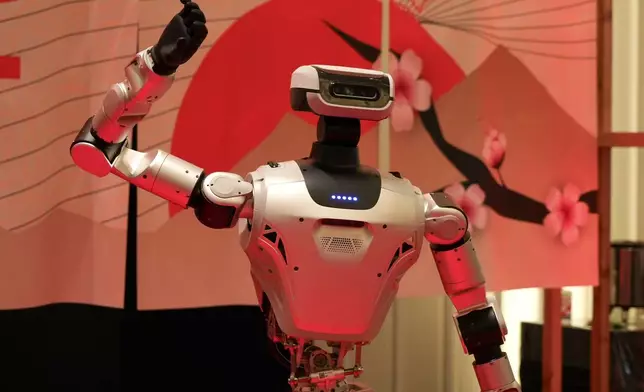 A humanoid robot poses for photo at the Humanoids Summit 2026 in Tokyo, Thursday, May 28, 2026. (AP Photo/Ayaka McGill)