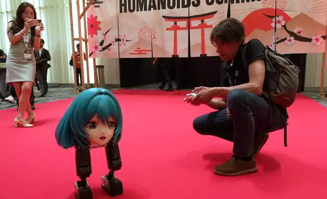 High Torque's Mini Pi bipedal robot is operated at the Humanoids Summit 2026 in Tokyo, Thursday, May 28, 2026. (AP Photo/Ayaka McGill)