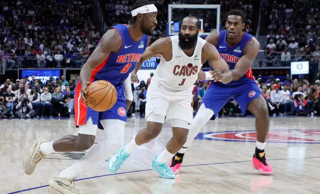 Detroit Pistons guard Caris LeVert (8) drives to the basket against Cleveland Cavaliers guard James Harden (1) with Pistons center Jalen Duren, right, helping on the play during the first half in Game 7 of a second-round NBA playoffs basketball series Sunday, May 17, 2026, in Detroit. (AP Photo/Duane Burleson)