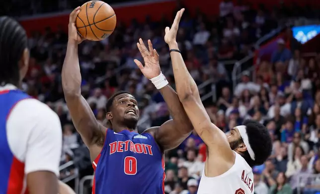 Detroit Pistons center Jalen Duren (0) takes a shot against Cleveland Cavaliers center Jarrett Allen during the first half of Game 7 in a second-round NBA basketball playoffs series, Sunday, May 17, 2026, in Detroit. (AP Photo/Duane Burleson)