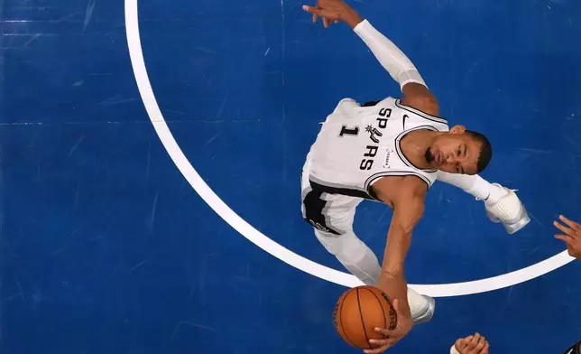San Antonio Spurs forward Victor Wembanyama (1) grabs a rebound during the second half of Game 3 of a NBA basketball second-round playoff series against the Minnesota Timberwolves, Friday, May 8, 2026, in Minneapolis. (AP Photo/Abbie Parr)
