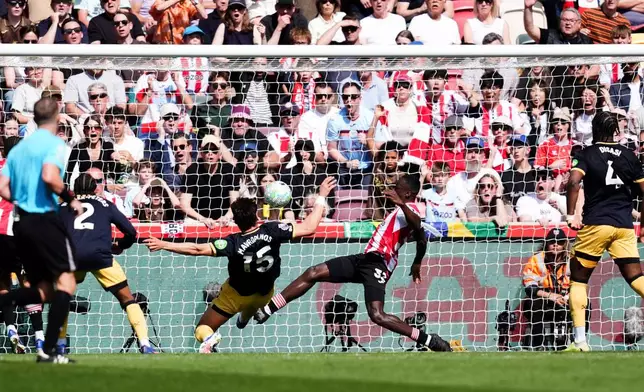West Ham United's Konstantinos Mavropanos scores an own goal during their English Premier League soccer match against Brentford in London, Saturday, May 2, 2026. (Mike Egerton/PA via AP)