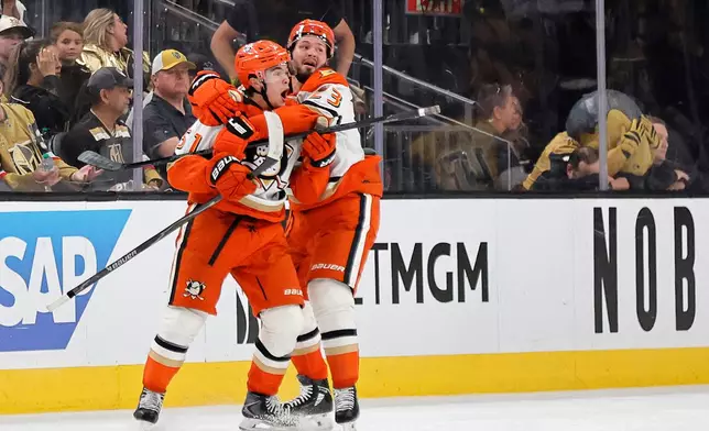 Anaheim Ducks defenseman Olen Zellweger (51) celebrates with center Mason McTavish (23) after scoring against the Vegas Golden Knights during the third period in Game 5 of a second-round NHL hockey Stanley Cup playoff series Tuesday, May 12, 2026, in Las Vegas. (Steve Marcus/Las Vegas Sun via AP)
