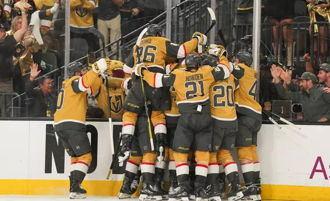 The Vegas Golden Knights celebrate defeating the Anaheim Ducks during overtime of Game 5 of a second-round NHL hockey Stanley Cup playoff series Tuesday, May 12, 2026, in Las Vegas. (AP Photo/Candice Ward)