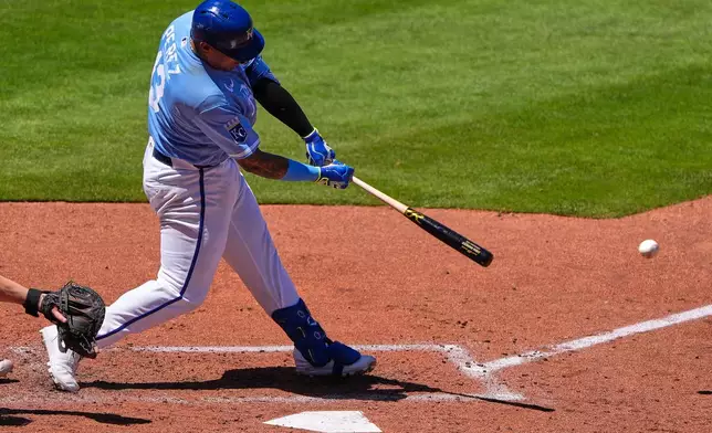 Kansas City Royals' Salvador Perez hits a two run single during the fifth inning of a baseball game against the Seattle Mariners, Sunday, May 24, 2026, in Kansas City, Mo. (AP Photo/Charlie Riedel)