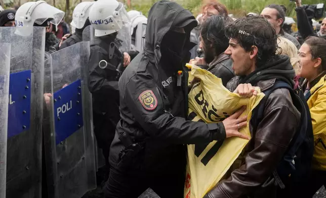 Union members scuffle with Turkish police officers as they try to march towards Taksim square in Istanbul, Turkey, Friday, May 1, 2026, during Labor Day celebrations. (AP Photo/Khalil Hamra)