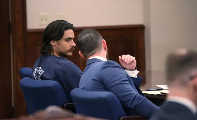 Dalton Eatherly, who goes by the moniker Chud the Builder, speaks with attorney Jacob Fendley during a hearing at the Montgomery County Courthouse, Thursday, May 21, 2026, in Clarksville, Tenn. (AP Photo/Adin Parks)