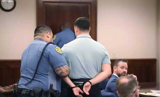 Jake Lang is escorted out of a hearing for Dalton Eatherly, who goes by the moniker Chud the Builder, at the Montgomery County Courthouse, Thursday, May 21, 2026, in Clarksville, Tenn. (AP Photo/Adin Parks)