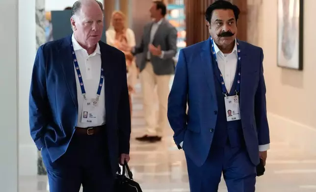 Mark Lamping, left, president of the Jacksonville Jaguars. and team owner Shahid Khan arrive at the NFL football owners' meetings Tuesday, May 19, 2026, in Orlando, Fla. (AP Photo/John Raoux)