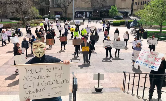 People protest outside the Ohio Statehouse on April 9, 2020, in Columbus, Ohio, on the state's shutdown of the economy, and to question the models used by Health Director Dr. Amy Acton to continue her shelter-at-home order during the pandemic. (AP Photo/Andrew Welsh-Huggins, File)