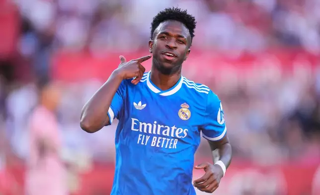 Real Madrid's Vinicius Junior celebrates after scoring the opening goal during the Spanish La Liga soccer match between Real Madrid and Sevilla in Seville, Spain, Sunday, May 17, 2026. (AP Photo/Jose Breton)