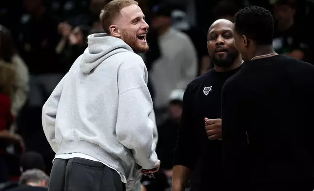 Minnesota Timberwolves guard Donte DiVincenzo, left, looks on during the second half of Game 6 of a first-round NBA basketball playoffs series against the Denver Nuggets, Thursday, April 30, 2026, in Minneapolis. (AP Photo/Matt Krohn)