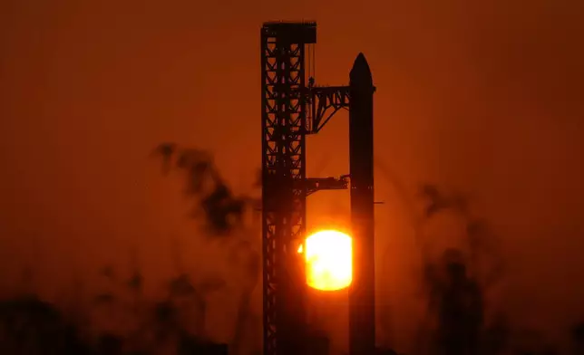 The sun rises behind SpaceX's mega rocket Starship as it is prepared for a test flight from Starbase, Texas, Friday, May 22, 2026. (AP Photo/Eric Gay)