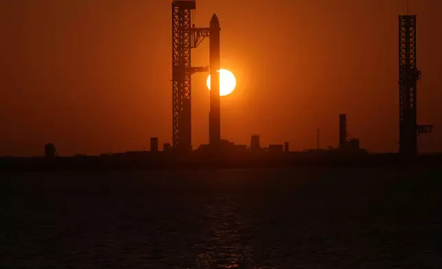 The sun rises behind SpaceX's mega rocket Starship as it is prepared for a test flight from Starbase, Texas, Friday, May 22, 2026. (AP Photo/Eric Gay)