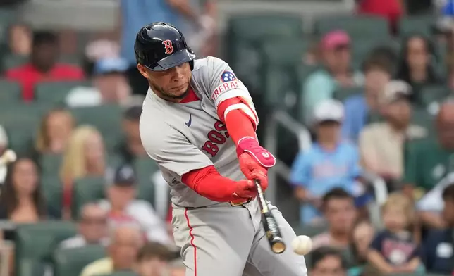 Boston Red Sox Willson Contreras (40) singles in the fourth inning of a baseball game against Atlanta Braves the Saturday, May 16, 2026, in Atlanta. (AP Photo/Brynn Anderson)