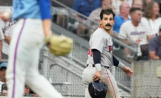 Boston Red Sox Mickey Gasper (30) looks back after he slides safely into home against Atlanta Braves catcher Sandy León in the fourth inning of a baseball game Saturday, May 16, 2026, in Atlanta. (AP Photo/Brynn Anderson)