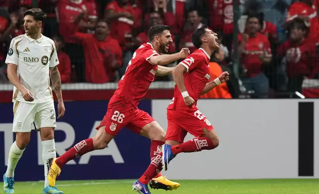 Everardo Lopez of Mexico's Toluca, right, celebrates scoring his side's 2nd goal against of the United States' Los Angeles FC during a CONCACAF Champions Cup second leg semifinal soccer match in Toluca, Mexico, Wednesday, May 6, 2026. (AP Photo/Fernando Llano)
