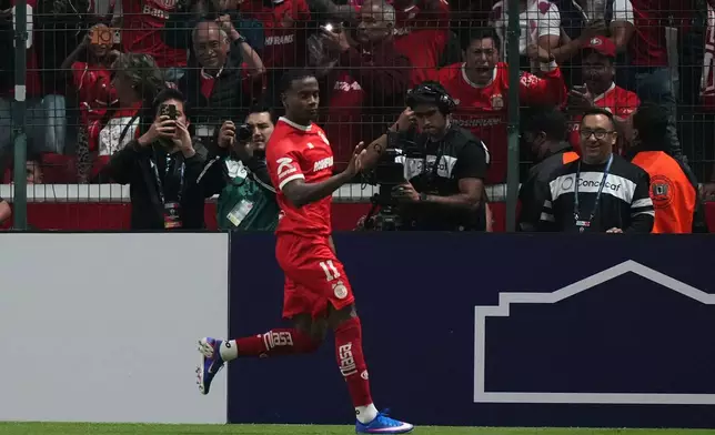 Helinho of Mexico's Toluca celebrates scoring his side's opening goal from the penalty spot against of the United States' Los Angeles FC during a CONCACAF Champions Cup second leg semifinal soccer match in Toluca, Mexico, Wednesday, May 6, 2026. (AP Photo/Fernando Llano)