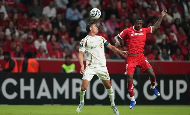 Aaron Long of the United States' Los Angeles FC, left, heads the ball past Helinho of Mexico's Toluca during a CONCACAF Champions Cup second leg semifinal soccer match in Toluca, Mexico, Wednesday, May 6, 2026. (AP Photo/Fernando Llano)