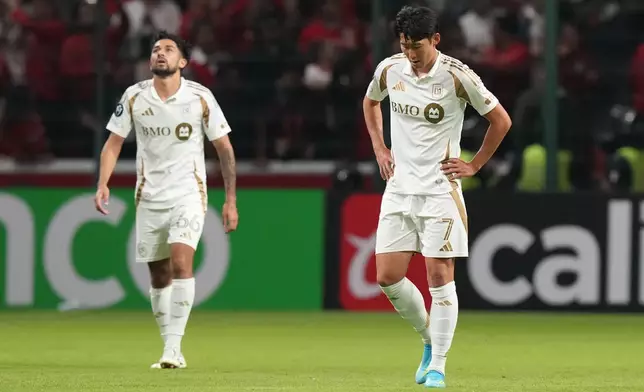 Son Heung-Min, right, and Mathieu Choiniere of the United States' Los Angeles FC react after Everardo Lopez of Mexico's Toluca scored during a CONCACAF Champions Cup second leg semifinal soccer match in Toluca, Mexico, Wednesday, May 6, 2026. (AP Photo/Fernando Llano)