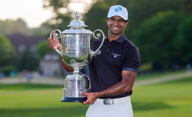 Aaron Rai, of England, holds the Wanamaker Trophy after winning the PGA Championship golf tournament at Aronimink Golf Club, Sunday, May 17, 2026, in Newtown Square, PA. (AP Photo/Matt Slocum)